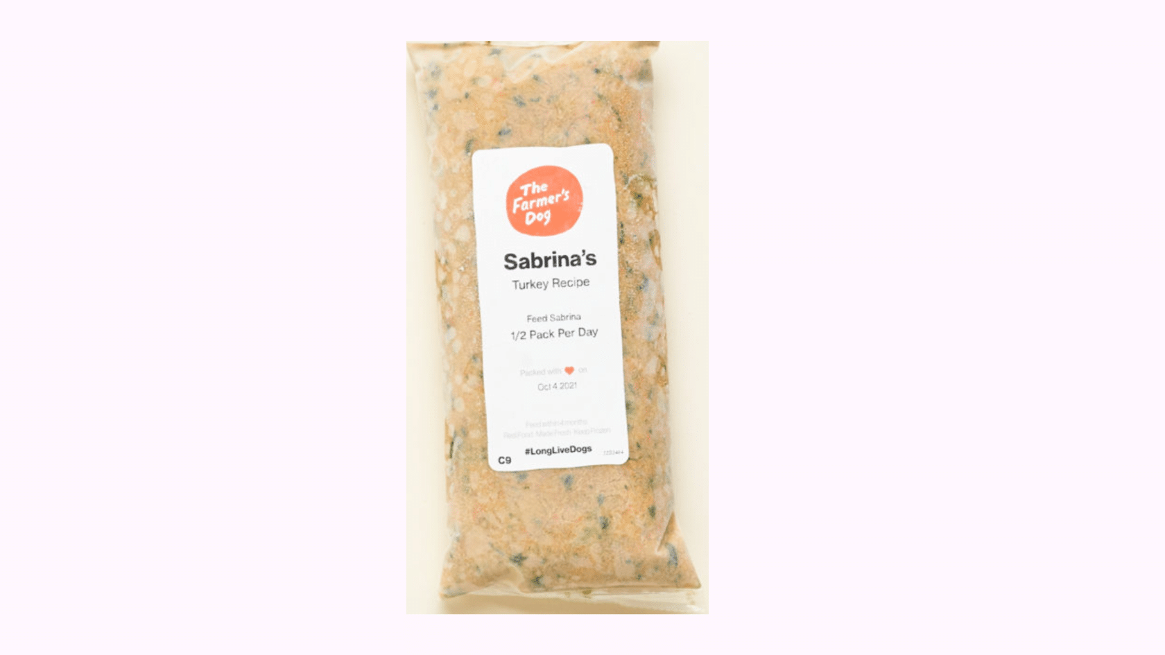 The Farmer’s Dog fresh turkey recipe dog food package beside a bowl of prepared dog food meal