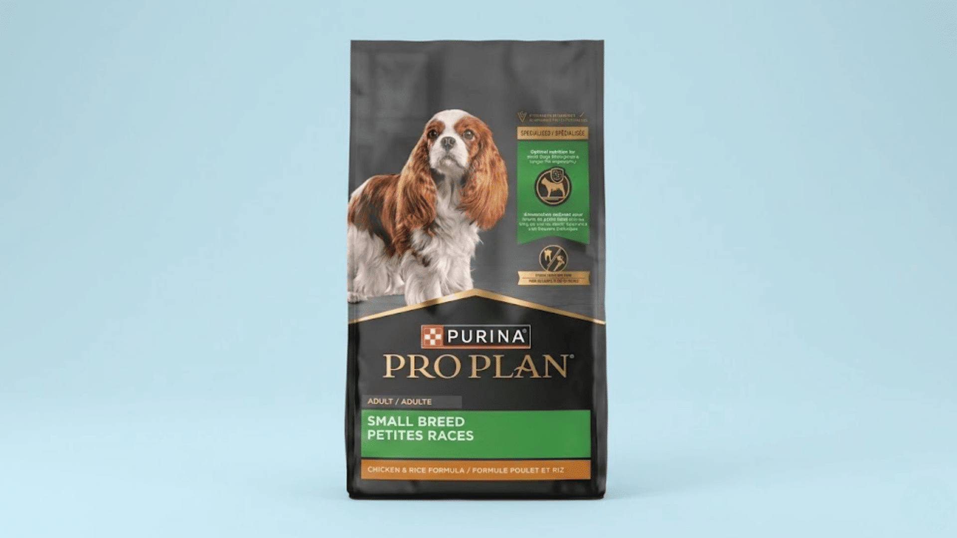 bag of purina pro plan small breed adult dog food with a cavalier king charles spaniel on a light blue background