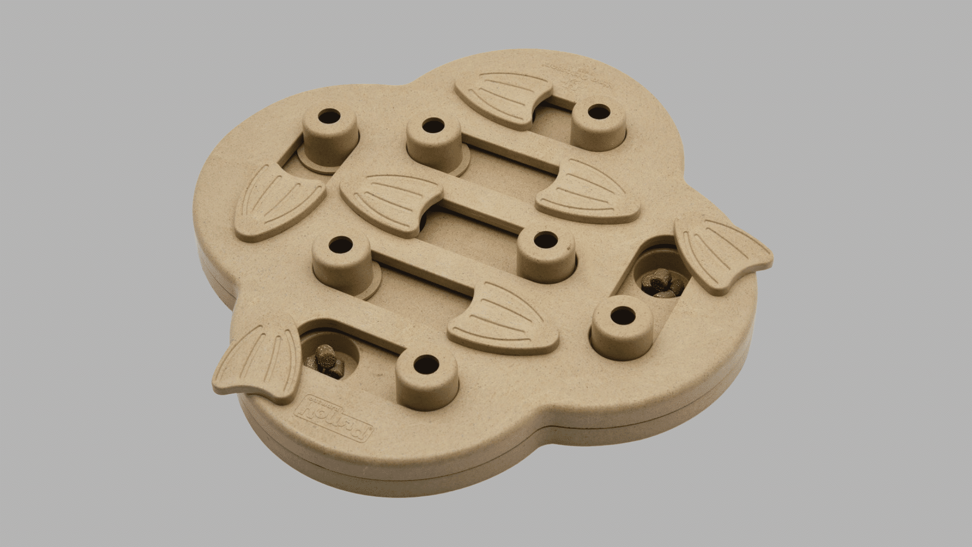 beige dog puzzle feeder with sliding fish shaped covers and hidden treat compartments arranged on a clover shaped board