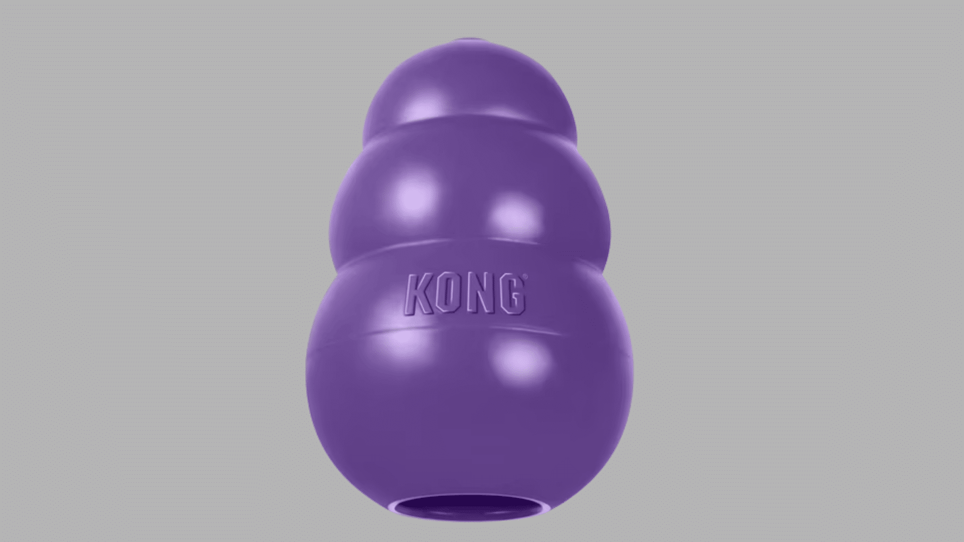 purple kong dog toy with stacked rounded shape and hollow opening at the base designed for treat dispensing and chewing
