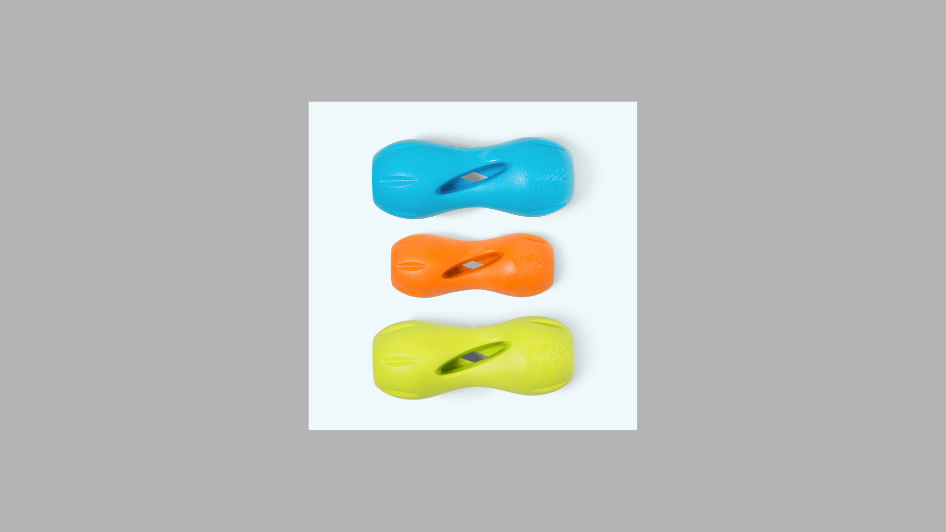 three rubber dog fetch toys in blue orange and yellow with curved shape and center opening displayed vertically on a plain background